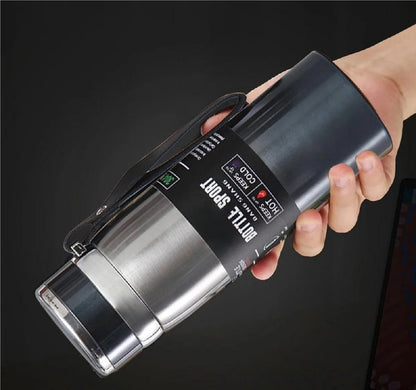 Hand holding a portable device with digital display on a dark background