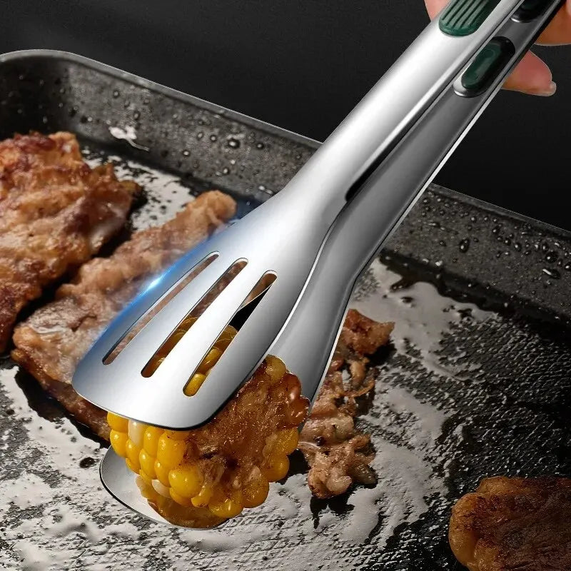 Metallic corn shuck removal tool being used on a piece of corn on a grill.