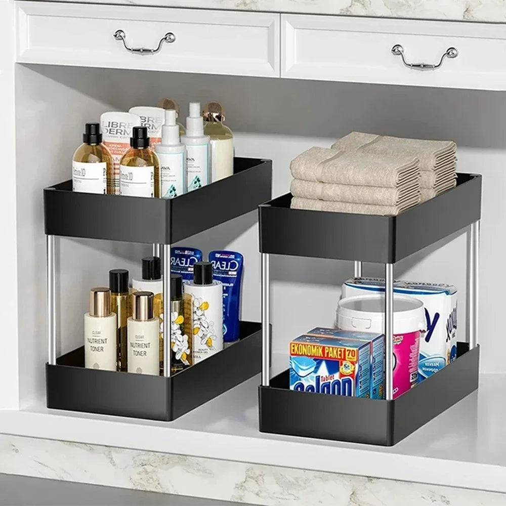 Black under-shelf storage baskets with bathroom products in a white cabinet.