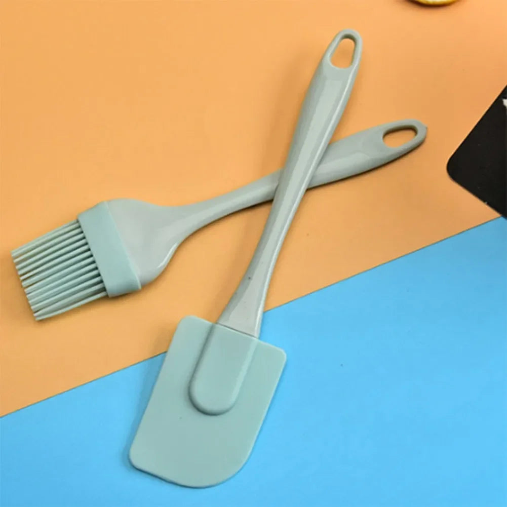 Two silicone kitchen utensils on a two-tone background