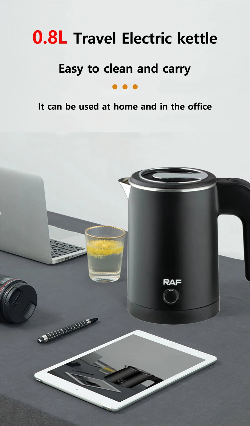 Black travel electric kettle on a desk with a laptop, glass of juice, and tablet.