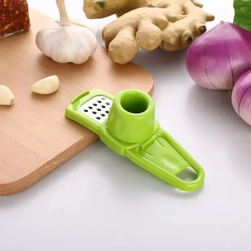 Green kitchen tool on a white surface with vegetables in the background