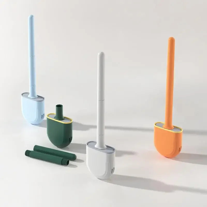 Set of four cleaning brushes with different colored handles on a light gray background