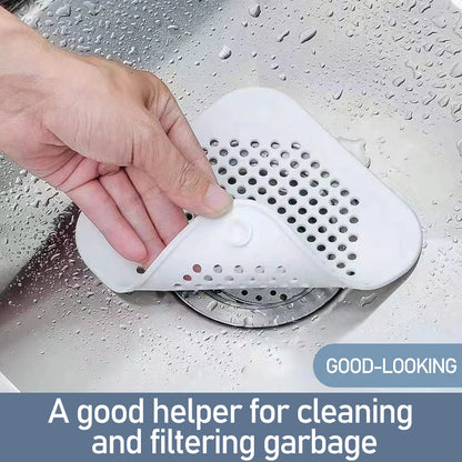 Hand using a white drain cover in a sink with text 'A good helper for cleaning and filtering garbage'.