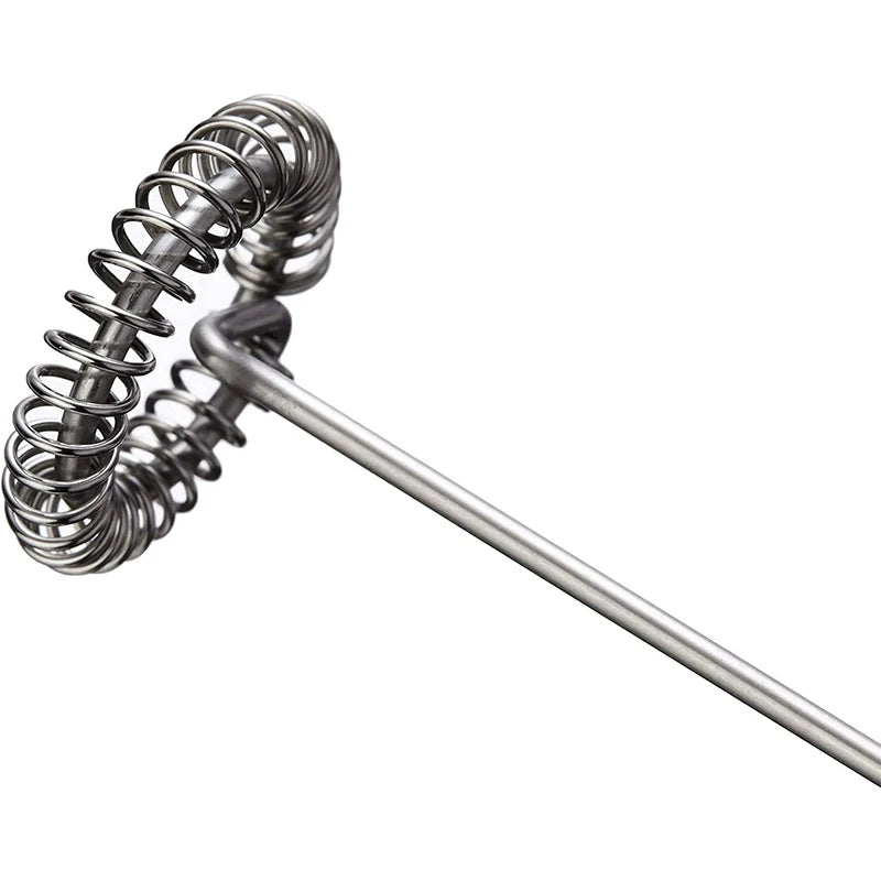 Metal whisk with coiled handle on a white background