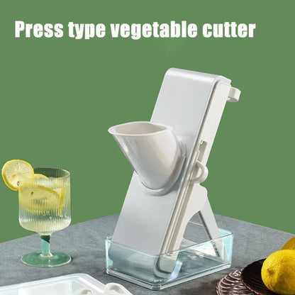 Press type vegetable cutter on a gray surface with a glass of lemonade and lemons in the background.