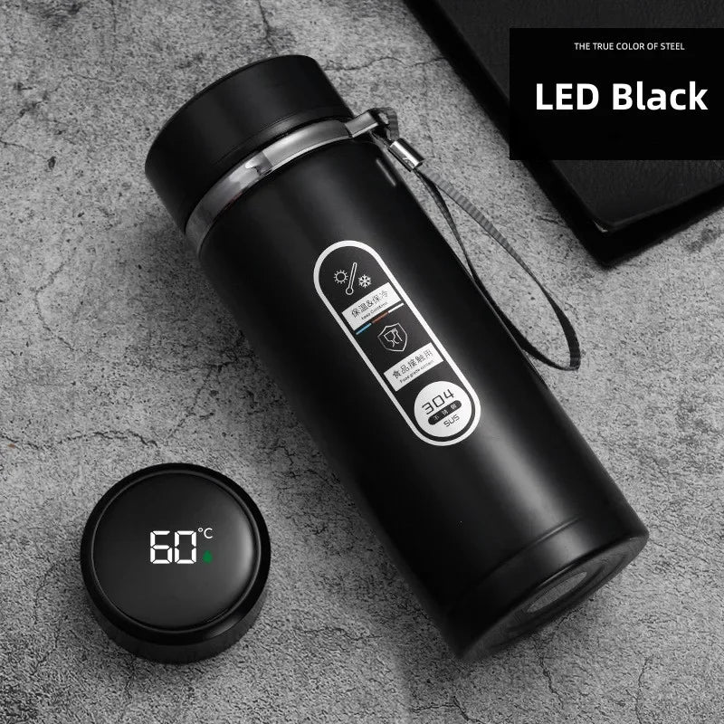 Black thermos bottle with digital temperature display on a gray surface