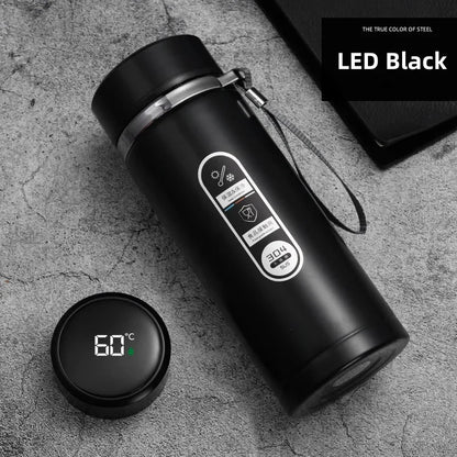 Black thermos bottle with digital temperature display on a gray surface