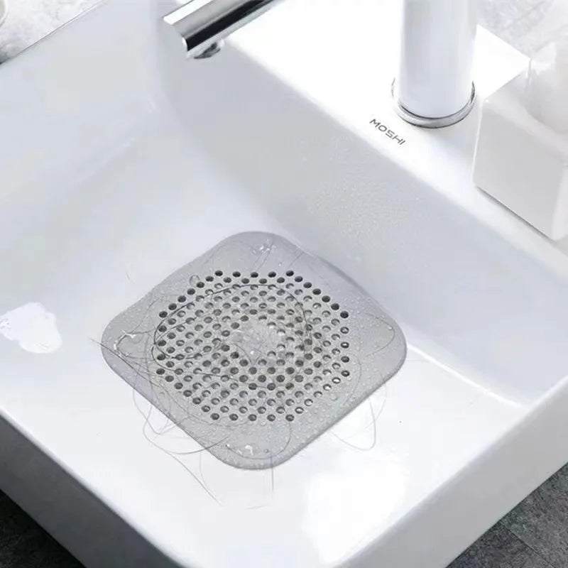 Gray drain cover on a white sink