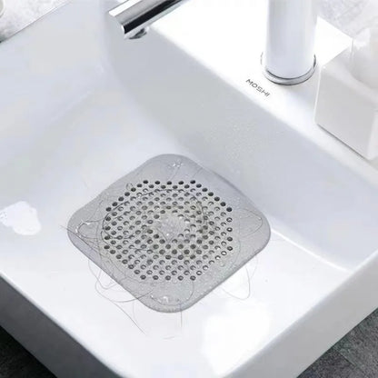Gray drain cover on a white sink